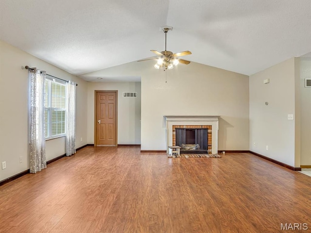 109 E Red Bud Ct, Valmeyer, IL 62295 - unfurnished living room with wood finished floors, ceiling fan, a brick fireplace, and lofted ceiling