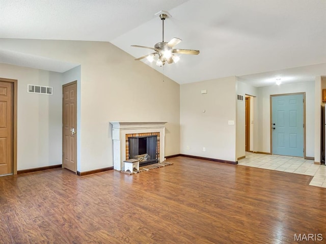 109 E Red Bud Ct, Valmeyer, IL 62295 - unfurnished living room featuring ceiling fan, light wood-style floors, vaulted ceiling, and a fireplace