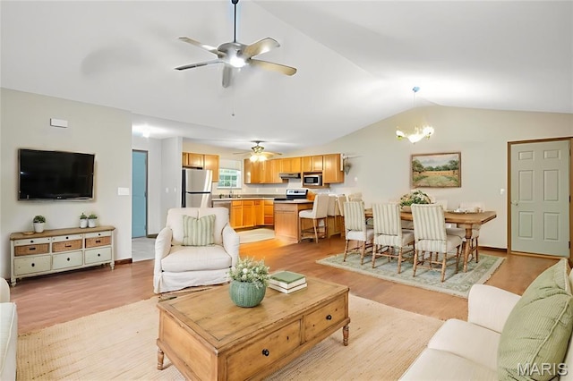 109 E Red Bud Ct, Valmeyer, IL 62295 - living area with light wood-type flooring, a ceiling fan, lofted ceiling, and a chandelier