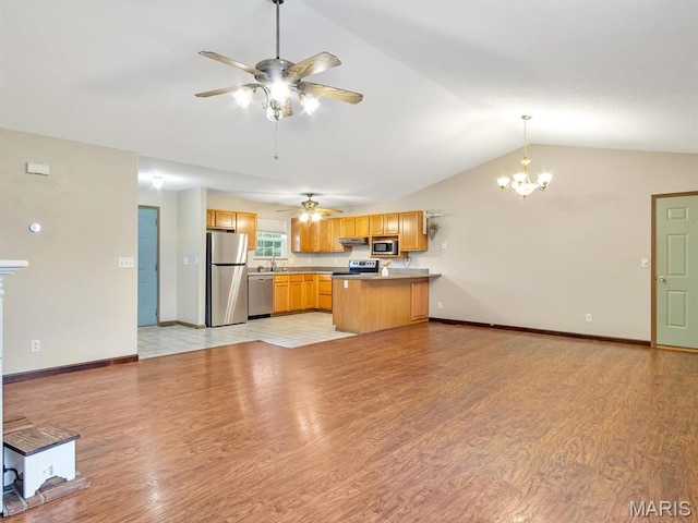 109 E Red Bud Ct, Valmeyer, IL 62295 - kitchen featuring appliances with stainless steel finishes, a peninsula, a chandelier, a ceiling fan, and vaulted ceiling