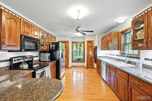18232 Prickly Pear Ct, Pacific, MO 63069 - kitchen featuring black appliances, light wood-style floors, glass insert cabinets, and ceiling fan