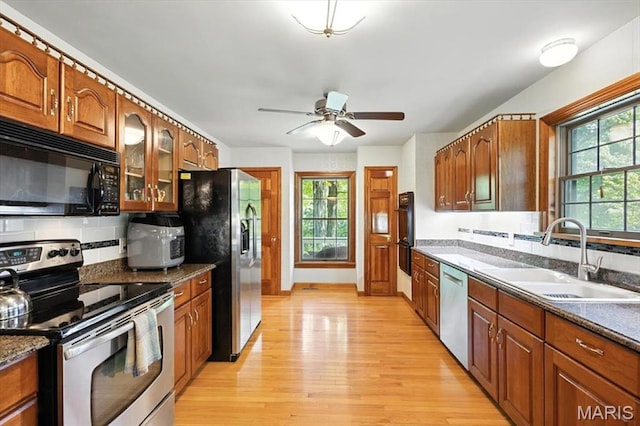 18232 Prickly Pear Ct, Pacific, MO 63069 - kitchen featuring black appliances, light wood-style floors, plenty of natural light, and backsplash