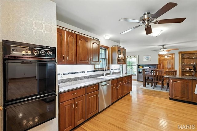 18232 Prickly Pear Ct, Pacific, MO 63069 - kitchen featuring stainless steel dishwasher, ceiling fan, dark countertops, and light wood-style flooring