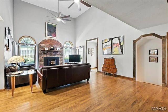 18232 Prickly Pear Ct, Pacific, MO 63069 - living room with a ceiling fan, a fireplace, light wood-style floors, and a high ceiling