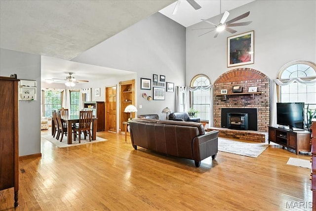 18232 Prickly Pear Ct, Pacific, MO 63069 - living room featuring a ceiling fan, high vaulted ceiling, light wood finished floors, and a fireplace