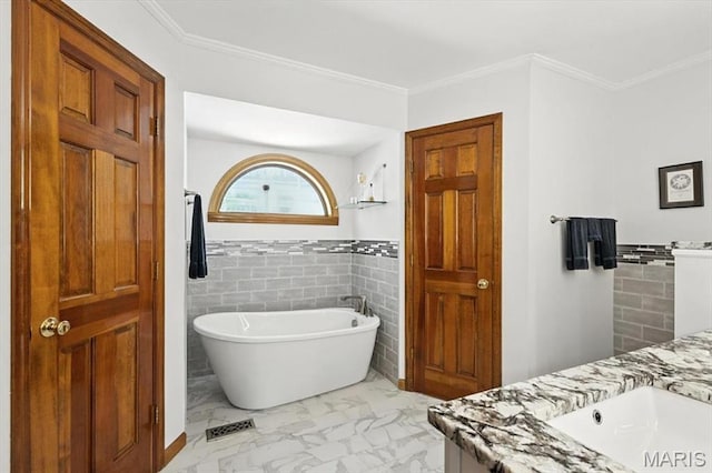 18232 Prickly Pear Ct, Pacific, MO 63069 - bathroom featuring tile walls, a freestanding tub, marble look tile flooring, vanity, and ornamental molding
