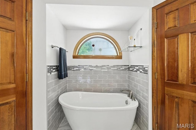 18232 Prickly Pear Ct, Pacific, MO 63069 - full bath featuring tile walls, a freestanding tub, and wainscoting