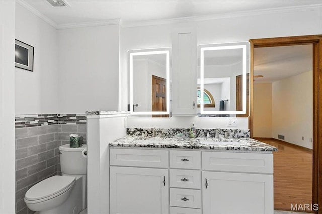 18232 Prickly Pear Ct, Pacific, MO 63069 - bathroom with double vanity, wood finished floors, tile walls, crown molding, and wainscoting