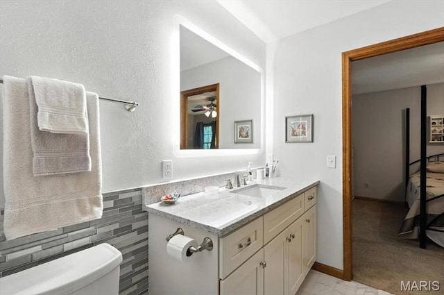 18232 Prickly Pear Ct, Pacific, MO 63069 - bathroom featuring vanity, tile walls, a ceiling fan, and wainscoting