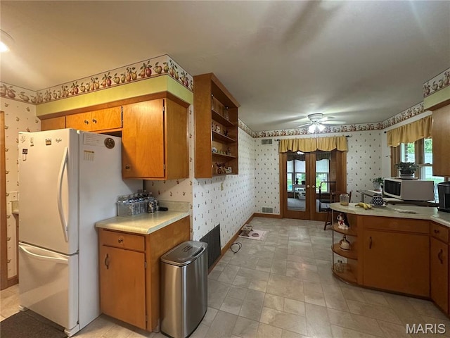 611 S Center, Shelbina, MO 63468 - kitchen featuring wallpapered walls, open shelves, white appliances, light countertops, and french doors
