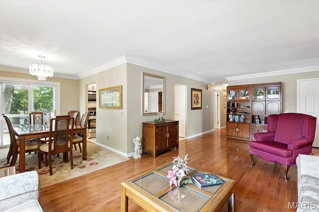 2342 Cedar Dale Ct, Maryland Heights, MO 63043 - living room featuring a chandelier, wood finished floors, ornamental molding, and baseboards