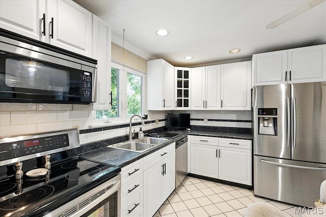 2342 Cedar Dale Ct, Maryland Heights, MO 63043 - kitchen featuring appliances with stainless steel finishes, a sink, white cabinets, decorative backsplash, and dark countertops