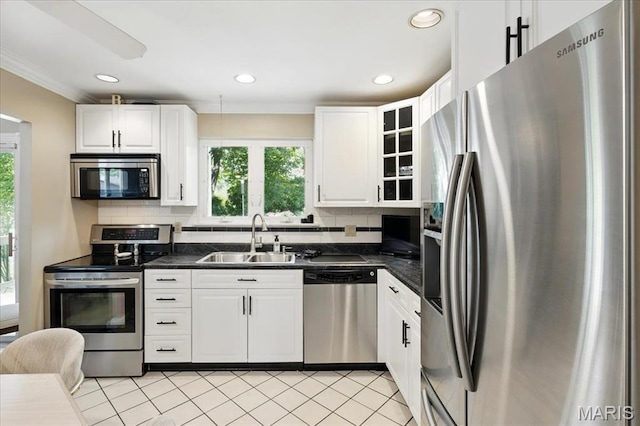 2342 Cedar Dale Ct, Maryland Heights, MO 63043 - kitchen featuring appliances with stainless steel finishes, a sink, dark countertops, crown molding, and healthy amount of natural light