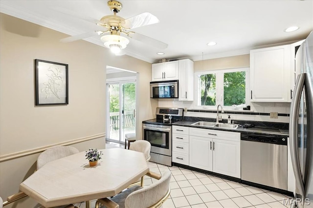 2342 Cedar Dale Ct, Maryland Heights, MO 63043 - kitchen with stainless steel appliances, a sink, dark countertops, decorative backsplash, and ornamental molding