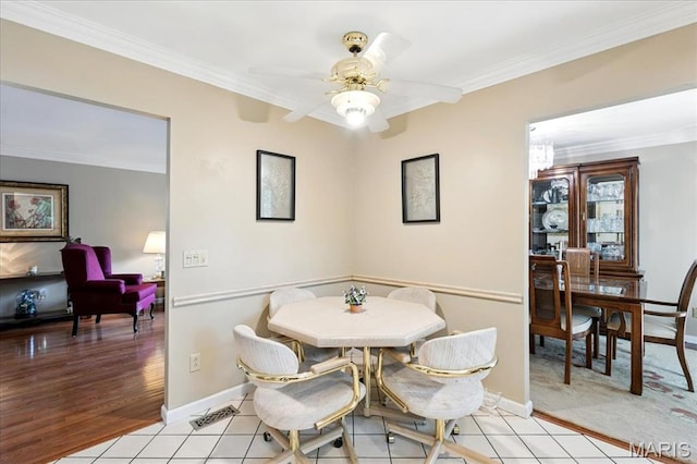 2342 Cedar Dale Ct, Maryland Heights, MO 63043 - dining area with crown molding, ceiling fan, light tile patterned flooring, and baseboards