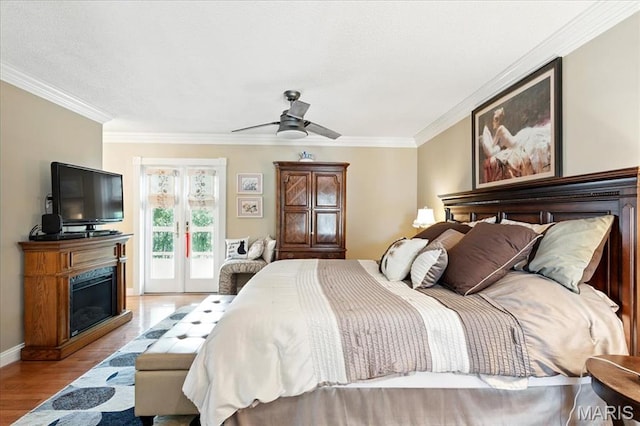 2342 Cedar Dale Ct, Maryland Heights, MO 63043 - bedroom with access to outside, light wood-type flooring, ornamental molding, a glass covered fireplace, and baseboards