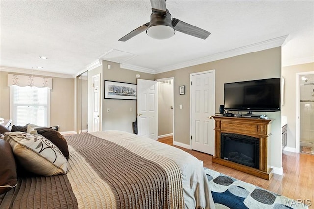 2342 Cedar Dale Ct, Maryland Heights, MO 63043 - bedroom featuring crown molding, wood finished floors, baseboards, a ceiling fan, and connected bathroom