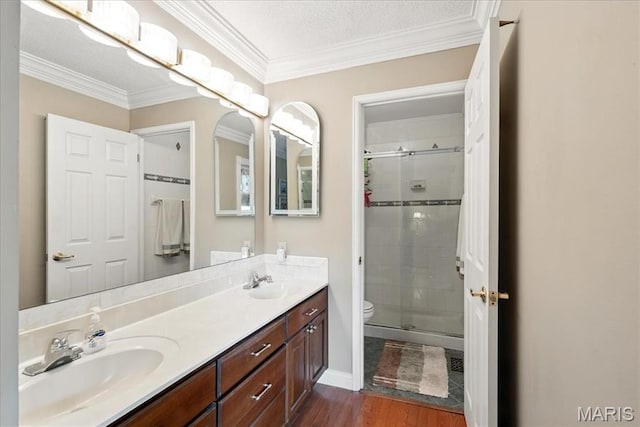 2342 Cedar Dale Ct, Maryland Heights, MO 63043 - full bath featuring a stall shower, double vanity, toilet, ornamental molding, and wood finished floors