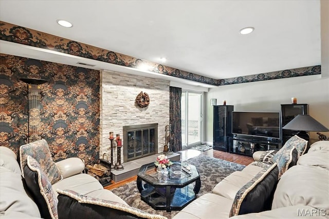 2342 Cedar Dale Ct, Maryland Heights, MO 63043 - living room with wood finished floors, a stone fireplace, and recessed lighting