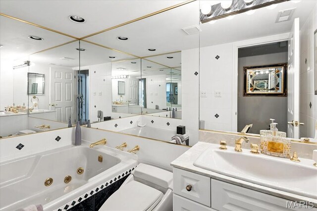 2342 Cedar Dale Ct, Maryland Heights, MO 63043 - bathroom with a tub with jets, vanity, toilet, and recessed lighting