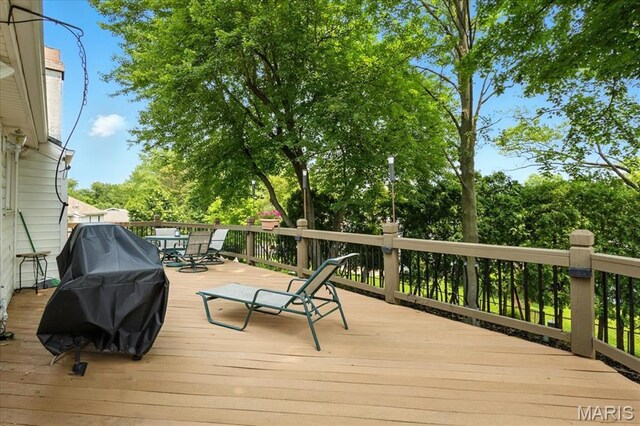 2342 Cedar Dale Ct, Maryland Heights, MO 63043 - wooden terrace featuring outdoor dining area, a grill, and view of scattered trees