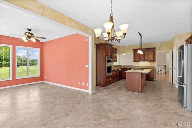 1609 10th Fairway Dr, Belleville, IL 62220 - kitchen with appliances with stainless steel finishes, open floor plan, a center island, a ceiling fan, and light tile patterned flooring
