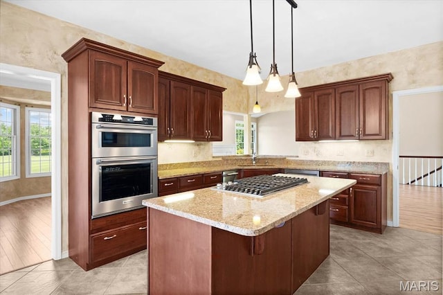 1609 10th Fairway Dr, Belleville, IL 62220 - kitchen with stainless steel appliances, light stone countertops, a center island, pendant lighting, and light tile patterned flooring