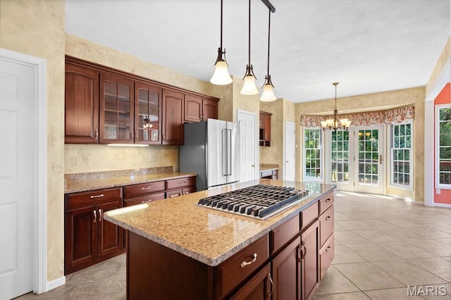 1609 10th Fairway Dr, Belleville, IL 62220 - kitchen featuring appliances with stainless steel finishes, a chandelier, glass insert cabinets, decorative light fixtures, and light stone countertops