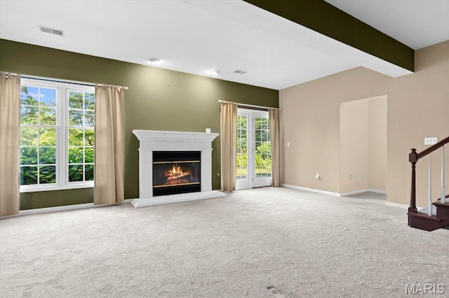 1609 10th Fairway Dr, Belleville, IL 62220 - unfurnished living room with carpet floors, a glass covered fireplace, and stairway