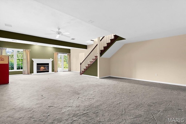 1609 10th Fairway Dr, Belleville, IL 62220 - unfurnished living room with carpet flooring, a ceiling fan, a glass covered fireplace, and healthy amount of natural light