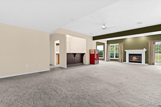 1609 10th Fairway Dr, Belleville, IL 62220 - unfurnished living room with carpet flooring, a glass covered fireplace, and ceiling fan