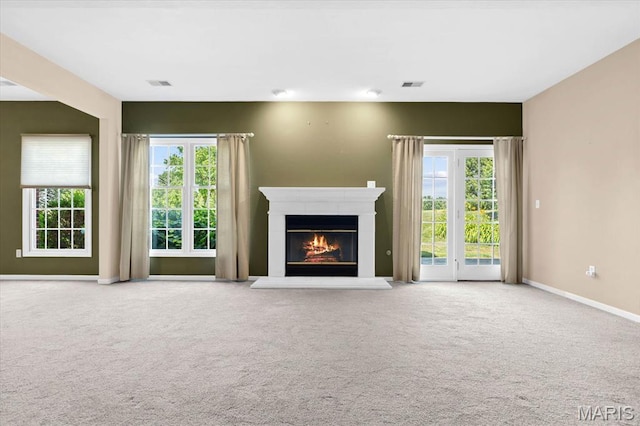 1609 10th Fairway Dr, Belleville, IL 62220 - unfurnished living room with carpet, a glass covered fireplace, and healthy amount of natural light
