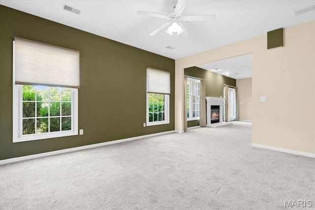 1609 10th Fairway Dr, Belleville, IL 62220 - unfurnished living room with carpet, a ceiling fan, and a glass covered fireplace