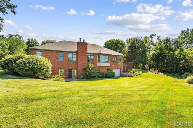 1609 10th Fairway Dr, Belleville, IL 62220 - back of property featuring brick siding, an attached garage, a chimney, and a yard
