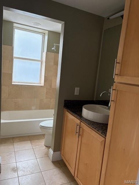 6114 Washington Blvd Unit 302, Saint Louis, MO 63112 - bathroom featuring toilet, vanity, tile patterned flooring, and bathing tub / shower combination
