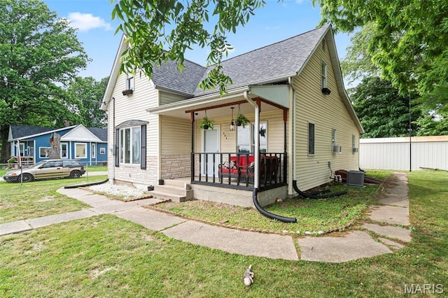 506 Russell St, Pocahontas, IL 62275 - view of front facade with covered porch, a shingled roof, a front lawn, and central air condition unit