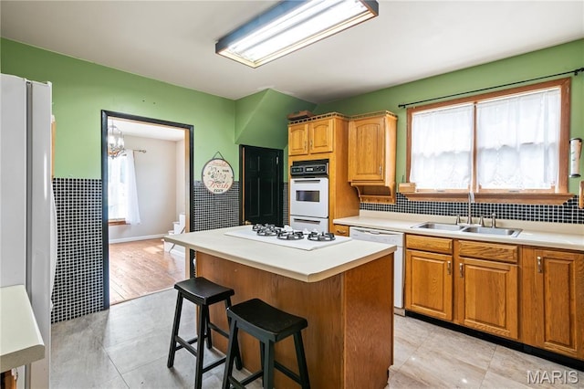 506 Russell St, Pocahontas, IL 62275 - kitchen with a sink, white appliances, light countertops, a breakfast bar, and a kitchen island