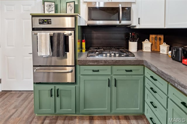 713 Fairway St, Bethalto, IL 62010 - kitchen with a warming drawer, appliances with stainless steel finishes, green cabinetry, and tasteful backsplash