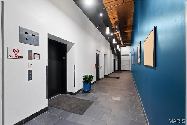507 N 13th St Unit 207, Saint Louis, MO 63103 - hallway featuring a high ceiling, elevator, and wood ceiling
