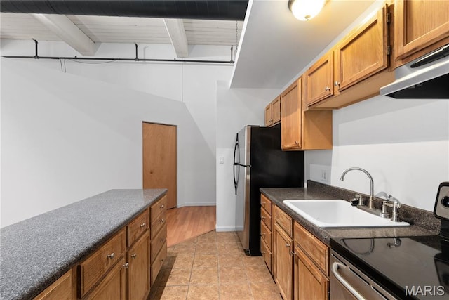 507 N 13th St Unit 207, Saint Louis, MO 63103 - kitchen featuring stainless steel appliances, dark countertops, beam ceiling, brown cabinetry, and extractor fan