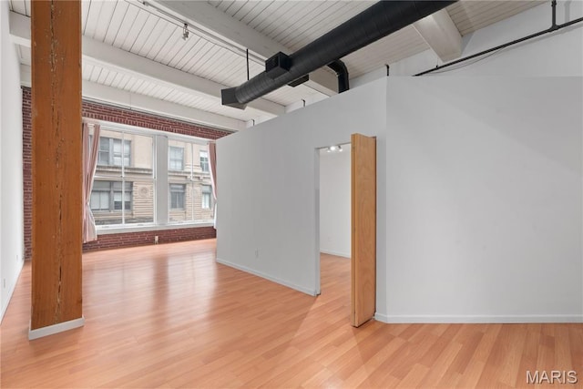 507 N 13th St Unit 207, Saint Louis, MO 63103 - empty room featuring beam ceiling and wood finished floors