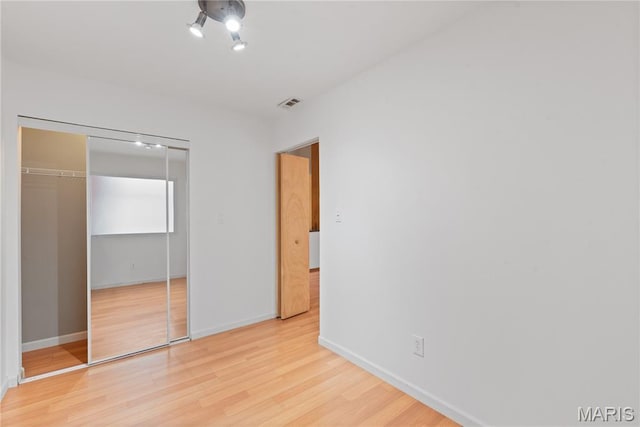 507 N 13th St Unit 207, Saint Louis, MO 63103 - unfurnished bedroom featuring light wood-style floors and a closet