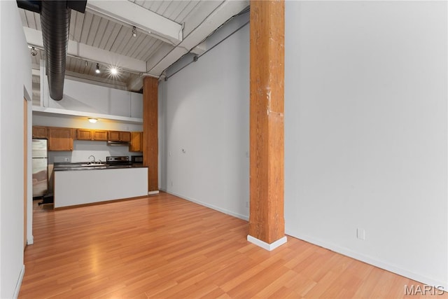 507 N 13th St Unit 207, Saint Louis, MO 63103 - unfurnished living room with light wood finished floors and beam ceiling