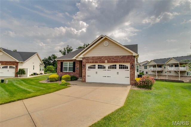 426 Vancroft Pl, Ofallon, IL 62269 - view of front facade featuring brick siding, a garage, driveway, and a front lawn