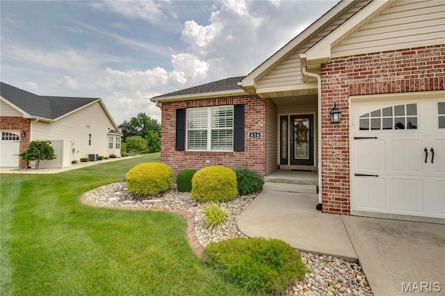 426 Vancroft Pl, Ofallon, IL 62269 - property entrance with brick siding, a lawn, and an attached garage