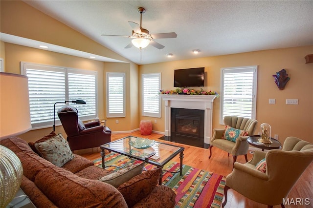 426 Vancroft Pl, Ofallon, IL 62269 - living room with a ceiling fan, a fireplace with flush hearth, wood finished floors, lofted ceiling, and a textured ceiling