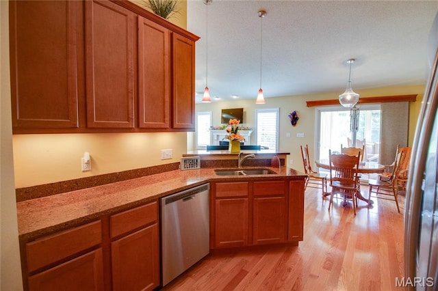 426 Vancroft Pl, Ofallon, IL 62269 - kitchen with dishwasher, a peninsula, light wood-style flooring, brown cabinets, and light stone counters