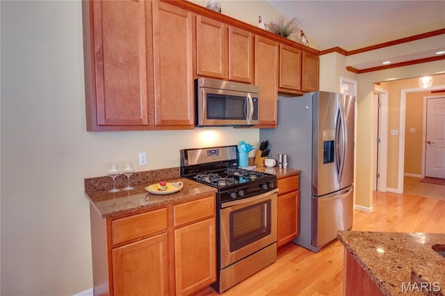 426 Vancroft Pl, Ofallon, IL 62269 - kitchen with stainless steel appliances, light wood finished floors, light stone countertops, ornamental molding, and brown cabinets