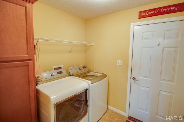 426 Vancroft Pl, Ofallon, IL 62269 - laundry area featuring washer and clothes dryer, light tile patterned flooring, a textured ceiling, and cabinet space