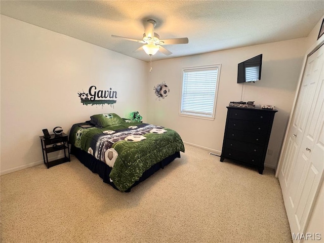123 Clover Rd, Hannibal, MO 63401 - bedroom featuring a closet, light colored carpet, baseboards, ceiling fan, and a textured ceiling
